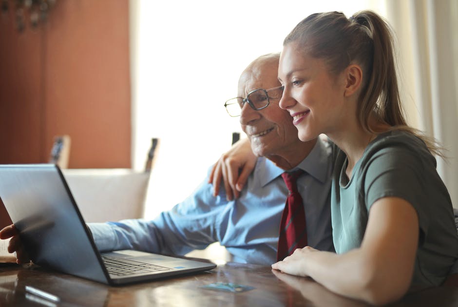 Senior woman and caregiver in kitchen